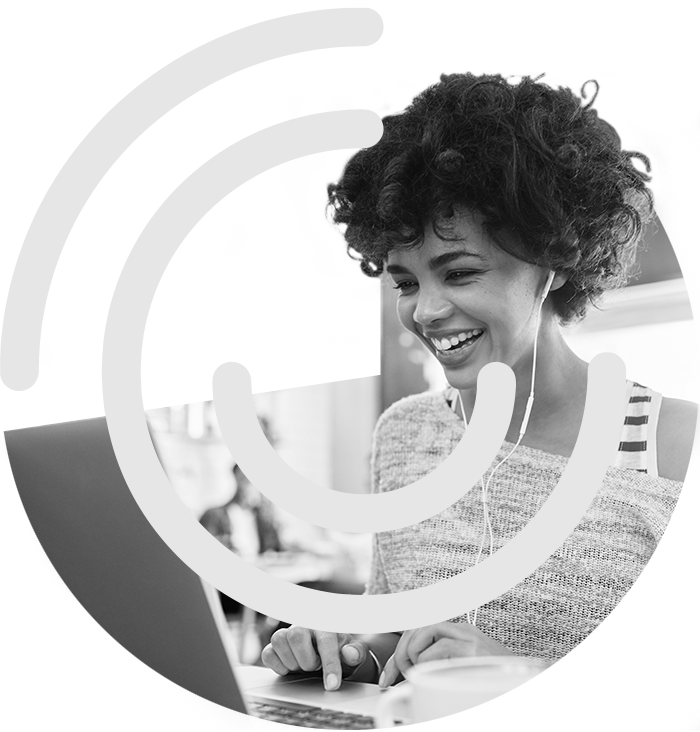 Lady wearing earphone working on laptop